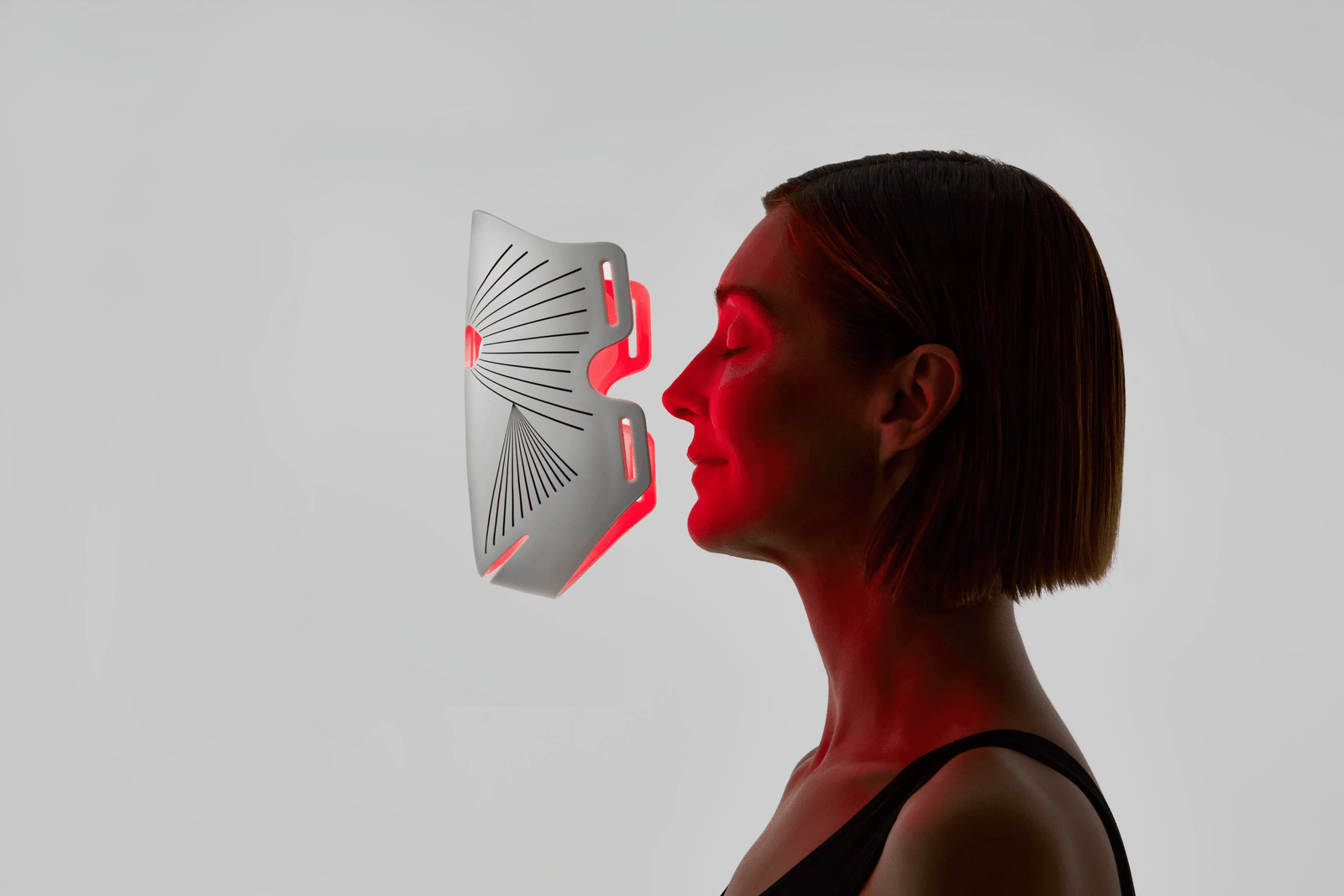 Red-light panel in front of woman